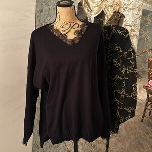 EUC black v neck sweater with faux lace underlay on sleeves and neck line only.